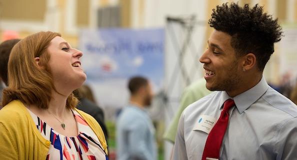 Two people talking at a career fair 