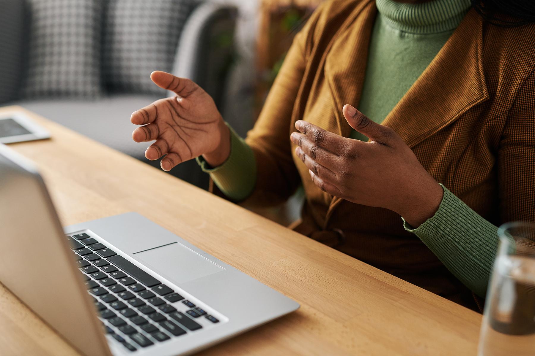 Woman talking to someone through a laptop