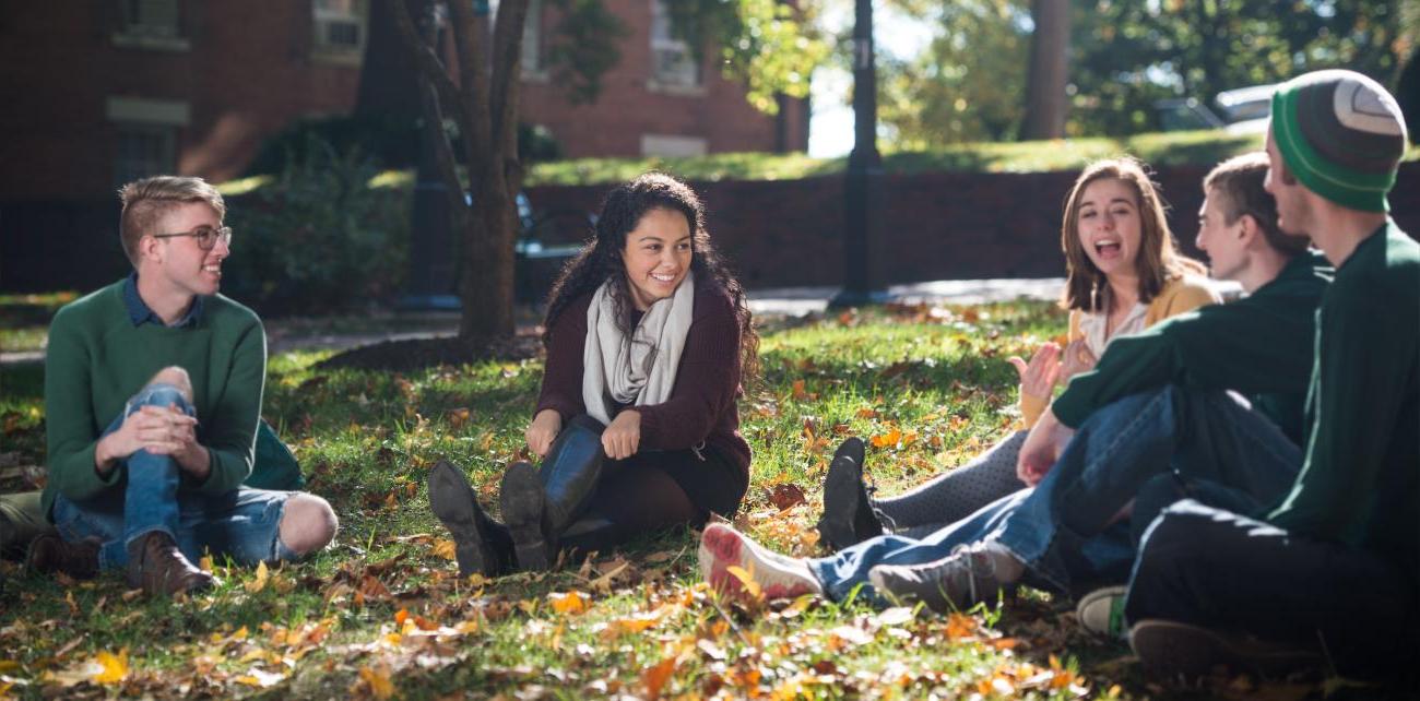 Students sitting in grass on College Green.