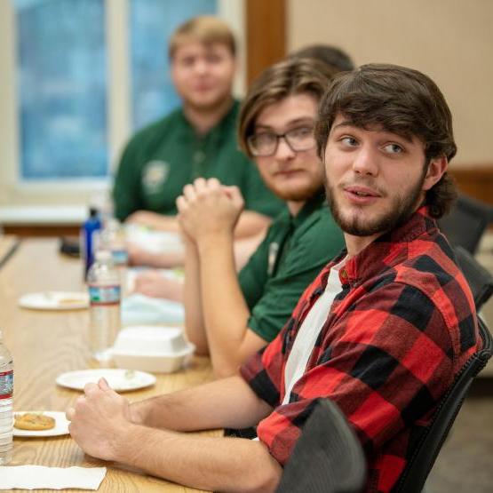 Three young men at table